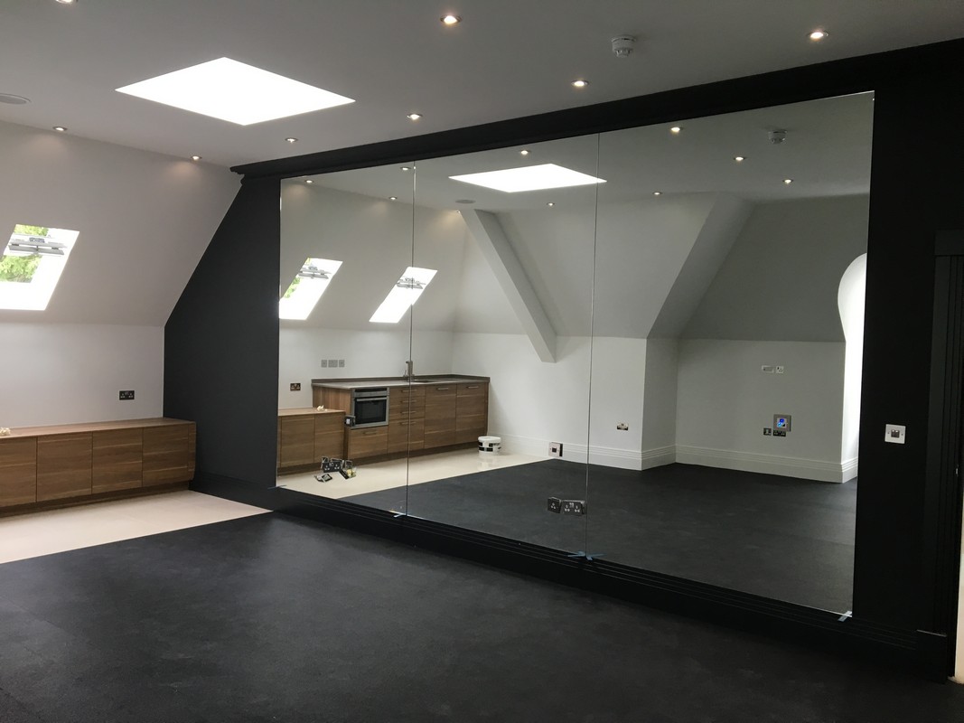 Frameless glass wall dividing loft conversion in Paddington