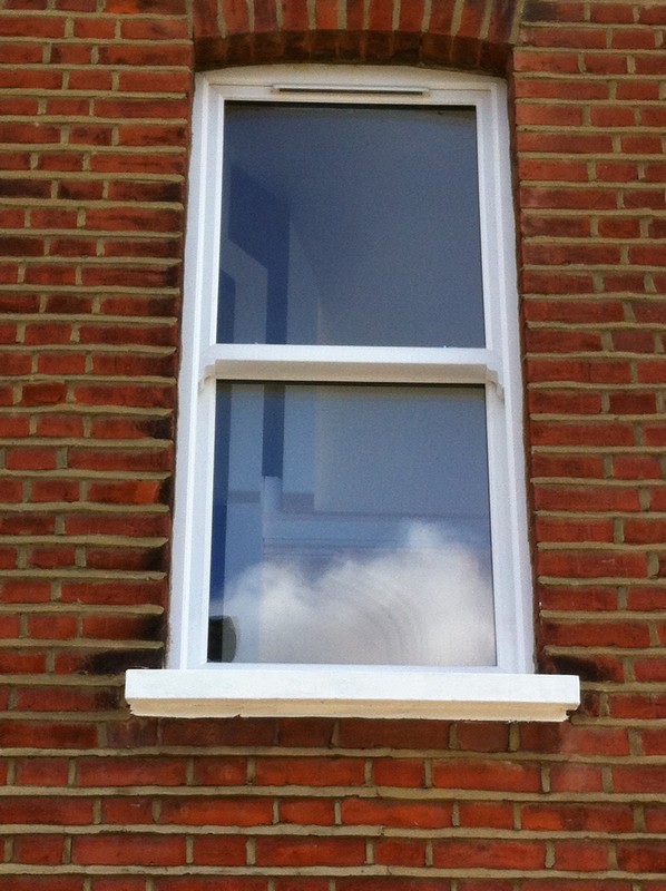uPVC sash window on Victorian red brick house in Paddington